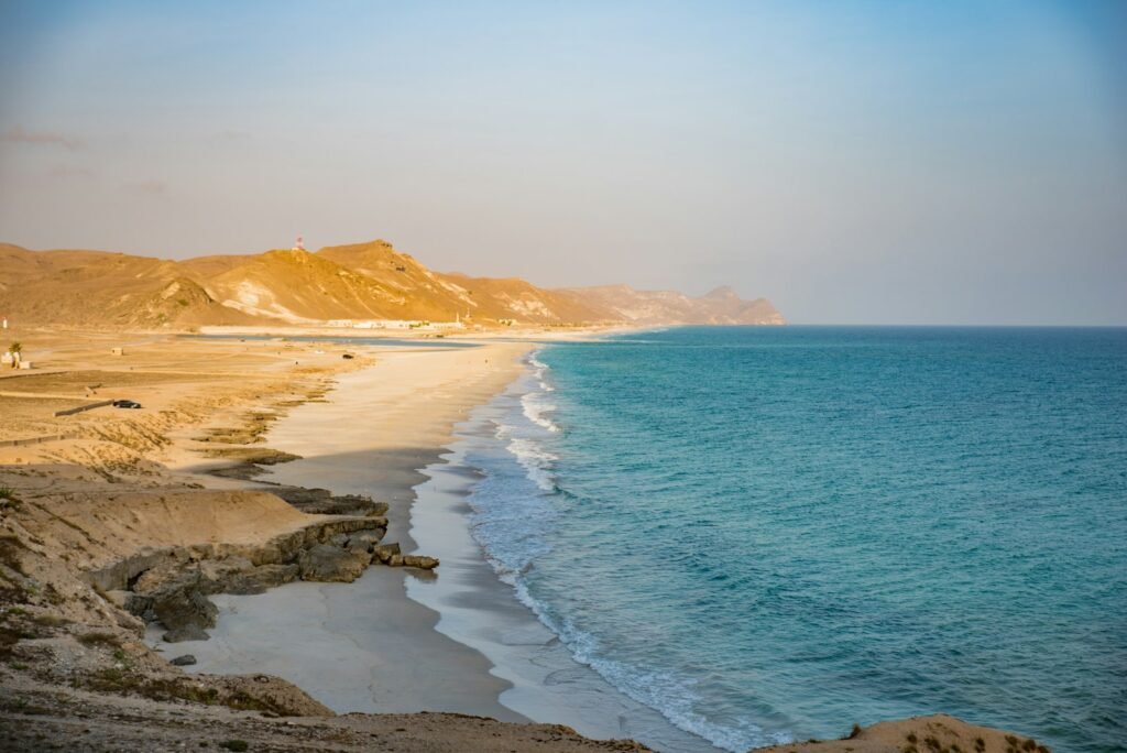 Sandy beach and coastline, illustrating Oman investment agreements led by a Dhofar tourism complex