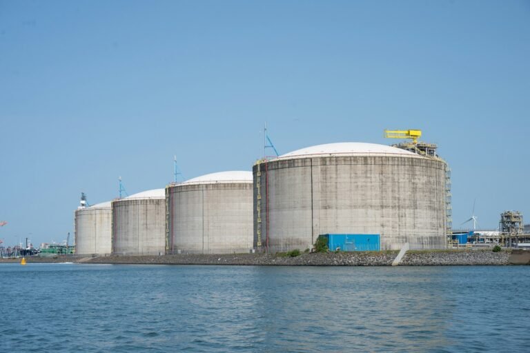 Fuel storage tanks at a waterside terminal, illustrating the Tristar acquisition by Aegis Logistics from Agility Global